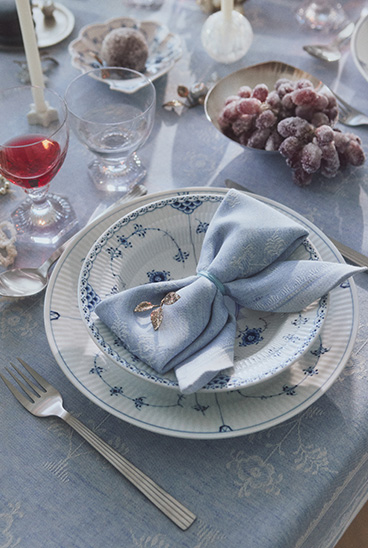 A Christmas table set with all Royal Copenhagen products, table cloth and napkins, glasses and porcelain